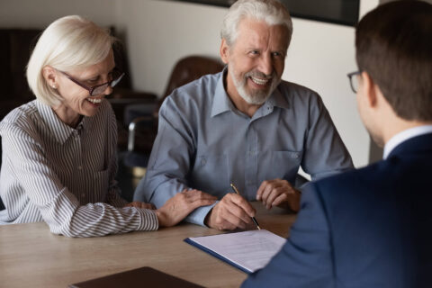 Happy customers signing a pre-paid funeral plan